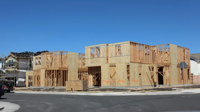 New townhouse construction site with wooden framing on a sunny day